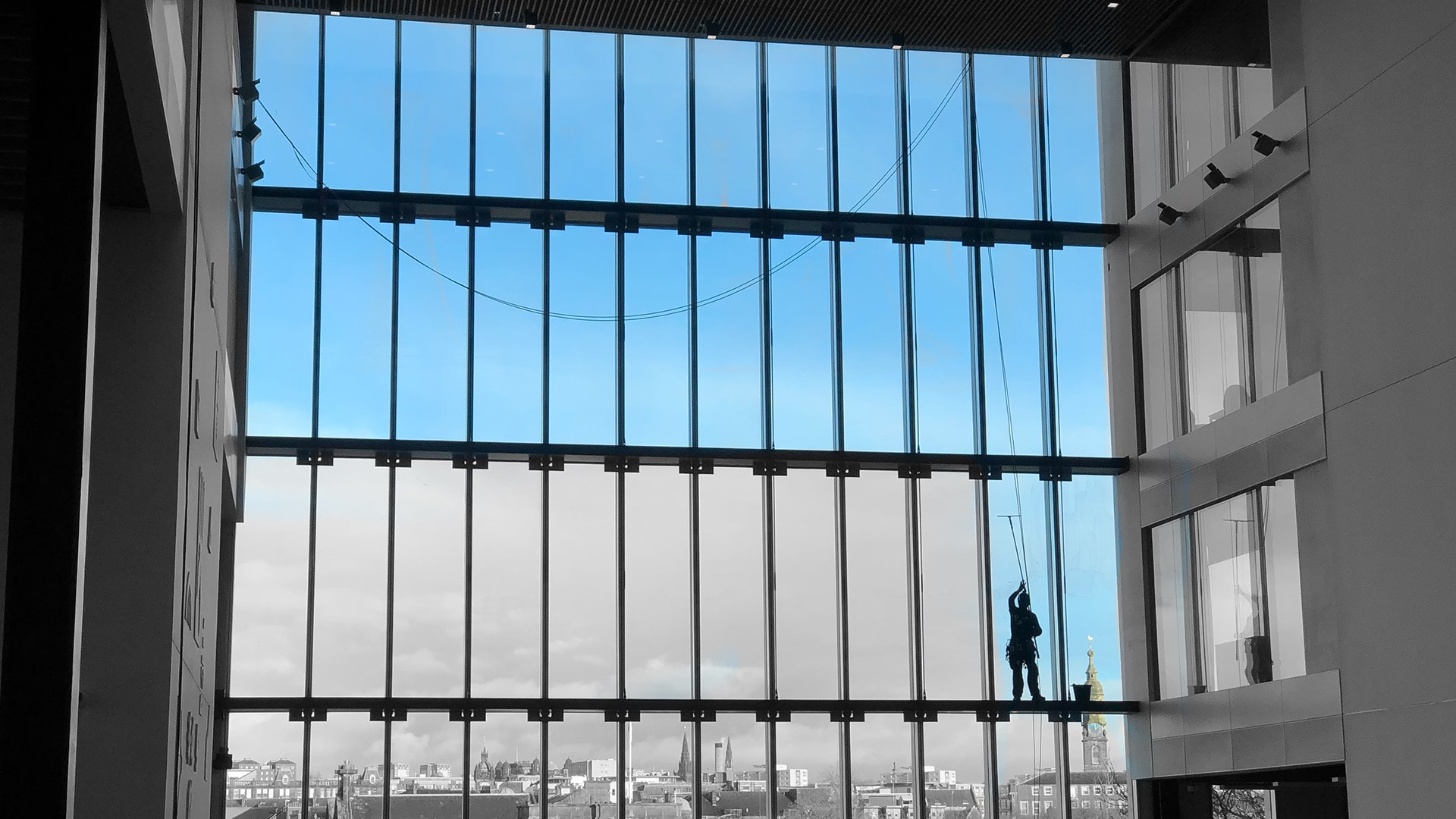 Struan Window Cleaning IRATA rope access technician cleaning commercial high-rise glass atrium in Scotland