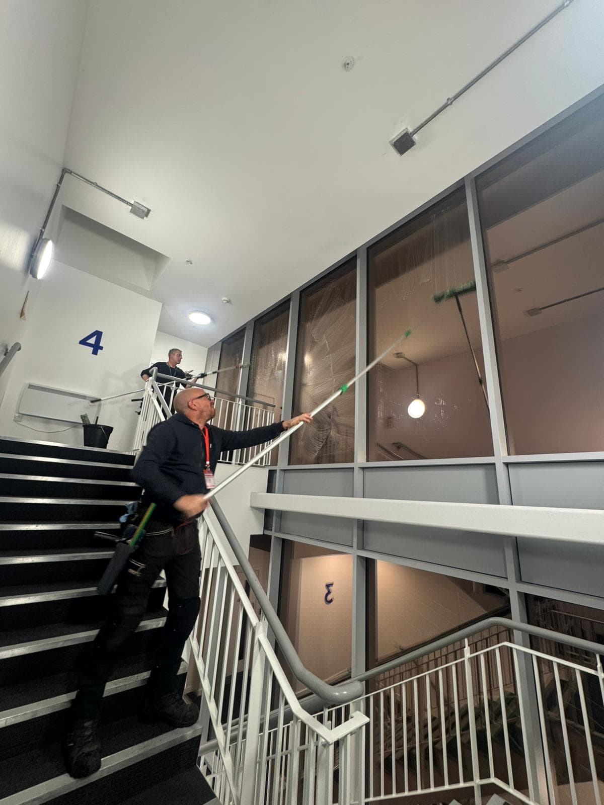 Internal window cleaning in Glasgow commercial building stairwell